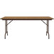 A Correll rectangular folding table with a medium oak wooden top and brown metal frame.
