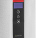 A stainless steel Grindmaster hot water dispenser with a red button and LCD screen.