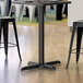 A Lancaster Table & Seating black counter height table with a black column base.