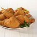 A plate of Golden Dipt Crispy Seasoned fried chicken with a side salad.