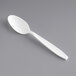 A white plastic Solo Impress teaspoon on a gray surface.