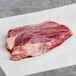 A TenderBison bison flank steak on a white surface.