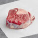 A piece of raw TenderBison Osso Bucco on a white paper.