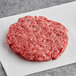 A raw TenderBison burger on white paper.