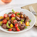 A plate of TenderBison steak tips with tomatoes.