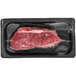 A TenderBison New York strip loin steak in a black plastic tray.