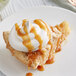 A slice of pie with whipped cream and DaVinci Gourmet Caramel Sauce on top.
