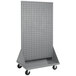 A grey metal cart with louvered shelves and wheels.