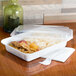 A Pactiv white rectangular plastic container with rice and chicken in it with a clear lid.