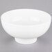 A white American Metalcraft porcelain footed bowl on a gray background.