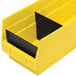 A yellow plastic Quantum storage bin with black dividers.