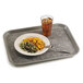 A Pearl Gray Cambro Non-Skid Versa Camtray with food and a drink on a table.