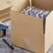A Lavex Kraft cardboard shipping box with clear plastic wrap inside.