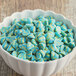 A close-up of blue and yellow Gertrude Hawk Monster Marshmallow Morsels.