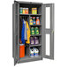 A gray Hallowell combination cabinet with Safety-View doors storing laundry detergents and cleaning supplies.