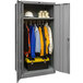 A grey metal Hallowell wardrobe cabinet with solid doors filled with clothes and tools.