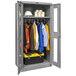 A grey Hallowell metal wardrobe cabinet with safety-view doors holding clothes and a toolbox.