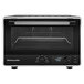 A matte black KitchenAid countertop convection oven with a glass door and digital display.