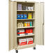 A tan Hallowell mobile storage cabinet with solid doors and shelves full of items.