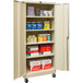 A Hallowell tan metal storage cabinet with shelves full of supplies.