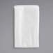 A white folded fleece filter dust bag with a silver handle.