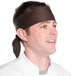 A chef wearing a brown Intedge bandana on his head.