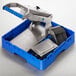 A blue and silver Edlund ARC! Manual Fruit and Vegetable Slicer in a blue plastic container.