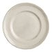 A close-up of an Acopa Condesa white porcelain plate with a scalloped white rim.