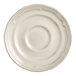 An Acopa Condesa warm gray porcelain saucer with a scalloped edge.