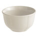 An Acopa Condesa warm gray porcelain bouillon cup with a scalloped design.