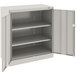 A light gray metal Tennsco storage cabinet with open doors.