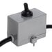 A grey electrical switch with a black toggle switch.