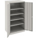 A Tennsco light gray metal storage cabinet with solid doors.