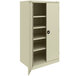 A white metal Tennsco storage cabinet with shelves and solid doors.