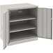 A light gray Tennsco metal storage cabinet with open doors.