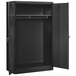 A black metal Tennsco wardrobe cabinet with solid doors open.