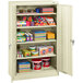 A Tennsco putty storage cabinet with many items on it.