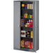 A dark gray Tennsco storage cabinet with shelves full of boxes.