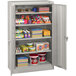 A light gray Tennsco storage cabinet with shelves full of items.
