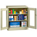 A Tennsco putty storage cabinet with C-Thru doors holding boxes.