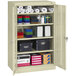 A Tennsco putty storage cabinet with solid doors and a shelf full of office supplies.