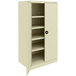A beige Tennsco metal storage cabinet with solid doors and shelves.