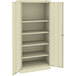 A beige metal Tennsco storage cabinet with solid doors.