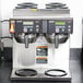 A Bunn Axiom coffee machine with two cups on top.