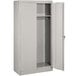 A light gray metal Tennsco wardrobe cabinet with solid doors open.