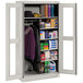 A light gray Tennsco combination cabinet with open C-Thru doors holding various items.
