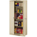 A Tennsco sand metal storage cabinet with solid doors and shelves full of items.