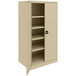 A tan Tennsco metal storage cabinet with shelves and solid doors.