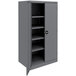 A dark gray metal Tennsco storage cabinet with solid doors and shelves.