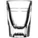 A clear Libbey fluted shot glass with a black line near the top.